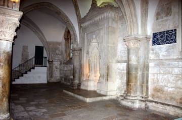 South wall with mihrab and Arabic plaque.