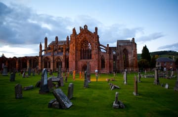 View of the abbey church from south at dusk. Ruins of Melrose Abbey, Melrose, Scotland.