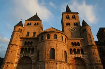 Romanesque west facade aglow at sunset.