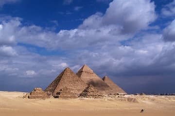 The Great Pyramids of Giza under the passing clouds.