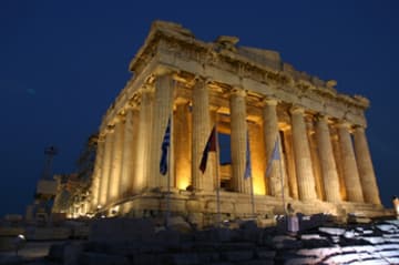 The Parthenon illuminated at night.