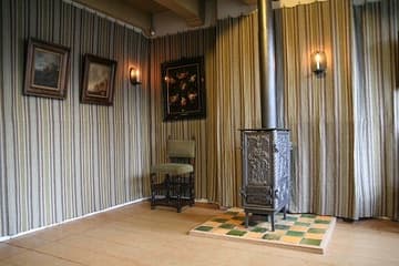 Canal Room or Day Room, on the canal side of the house, dating from 1663 and fitted with contemporary furniture. The stove is a replica. Museum Amstelkring (Ons' Lieve Heer op Solder, "Our Lord in the Attic"). Amsterdam, The Netherlands.