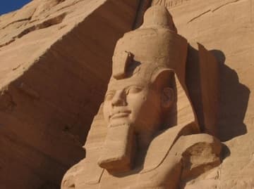 The Temple of Ramses II at Abu Simbel, completed in 1264 BC and dedicated to Ra-Harakhty, Ptah and Amun. It features four large statues of Ramses II on the facade.