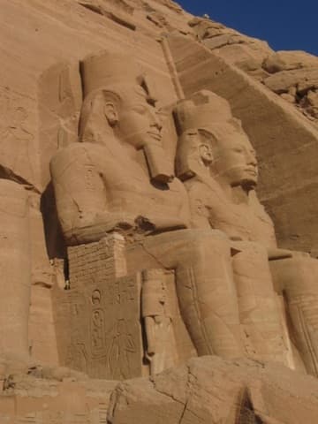 The Temple of Ramses II at Abu Simbel, completed in 1264 BC and dedicated to Ra-Harakhty, Ptah and Amun. It features four large statues of Ramses II on the facade.
