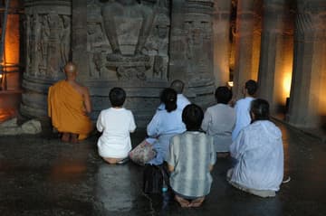 Buddhists worship at the Buddha's feet.