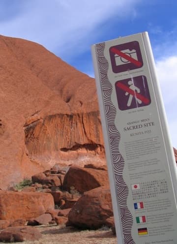 A sign prohibits access to a part of Uluru still used for Anangu rituals.