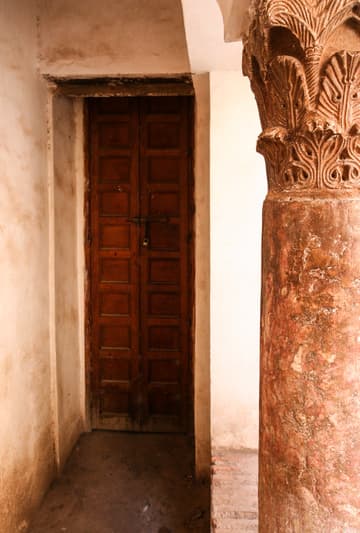 Small door and column with carved capital at the Saadian Tombs, Marrakesh, Morocco.