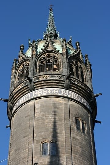 Top of the Great Tower (1496), a sturdy round tower at the west end of the church. A modern band around the tower reads "Ein feste Burg ist unser Gott" - the German title of Luther's famous hymn,