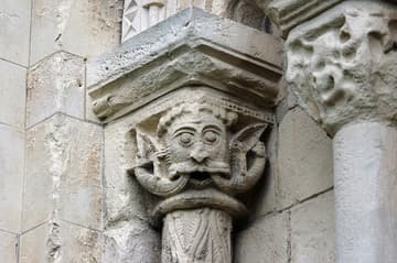 Weathered Romanesque capital of a Green Man on the exterior of the southeast transept, 12th century. Canterbury Cathedral, England.