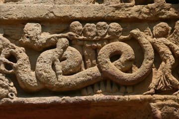 A coiled serpent tormenting the damned in Hell. Detail of the south door in the outer wall, which was originally a main entrance into the priory. The tympanum dates from the mid-12th century and is crowded with lively sculptures.