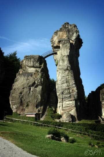 Two pillars of Exsternsteine and the metal bridge leading to the solstice-aligned chapel.