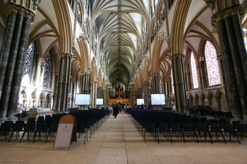 The nave, looking east. The chairs and video screens are in place for a degree ceremony of the University of Lincoln.