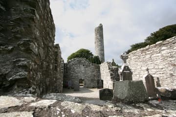 Ruined church and round tower. Monasterboice's round tower is over 30m (110 feet) tall and was divided into four or more stories inside, connected with ladders.