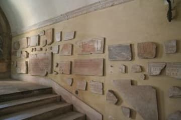 Artifacts from the catacombs line the stairway into the church.