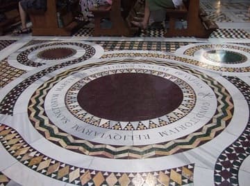 A porphyry disk in the back of the nave, which is said to mark a well where St. Prassede placed the bones of martyrs.