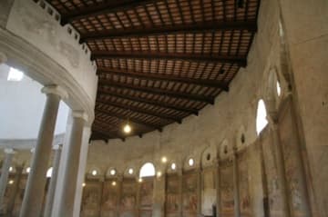 Looking right: outer aisle and wall with violent 16th-century frescoes.