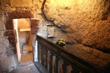 The Grotto of St. Francis, around which the convent was built. On the right is the stone bed used by the saint during periods of retreat toward the end of his life.