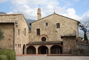 Facade of the convent, the left portion of which is the original oratory rebuilt with St. Francis' own hands. It was later enlarged to the right.