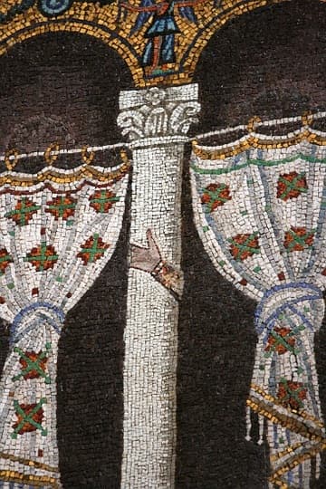 Detail of nave mosaic at the west end of Sant'Apolllinare Nuovo, Ravenna, depicting Theodoric's Palace. The mosaic dates from c.500 AD under Theodoric, but in c.560, the Arian king and his court were excised from the palace and replaced with black backgrounds and curtains. A hand belonging to one of the original occupants can still be seen on some columns.