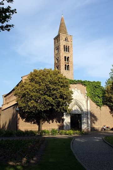View of San Giovanni Evangelista from the west. The basilica was built c.426-30 by Galla Placidia, in fulfillment of a vow. It was badly damaged by bombs in 1944 but rebuilt to its original form. The campanile dates from the 10th to 14th centuries; the marble portal is from the 14th century.