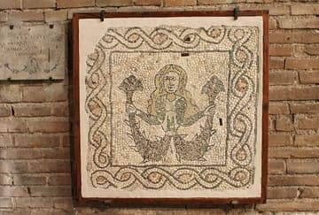 Fragment of Romanesque mosaic floor (1213 AD) in San Giovanni Evangelista, Ravenna, depicting a blonde mermaid (or siren) with a thorny double tail.