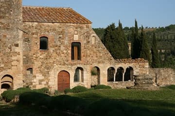 Remains of the cloister of the Abbey of Sant'Antimo in Tuscany. The three arches on the right were part of the chapter house and date from the 8th century. Originally founded in Carolingian times (770) along the Via Francigena, the Benedictine abbey was rebuilt in 1118.