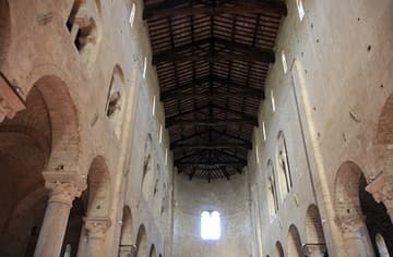 View of high nave vaults and wooden ceiling of the Abbey of Sant'Antimo in Tuscany. Said to have been founded by Charlemagne in 781, the present abbey church dates from 1118.