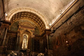 Inside the Holy House of the Virgin Mary, which is said to have been flown from Nazareth to Italy by angels after the Crusades. The fresco fragments on the walls date from the 14th century; the vault was added in the 15th century. The robed statue of the Virgin and Child, made of black cedar wood, is a copy of the ancient original that was destroyed by fire in 1921.