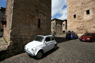 A classic Fiat parked in the lower plaza of the Cattedrale di Santa Maria (1079-1104), Anagni, Lazio, Italy.