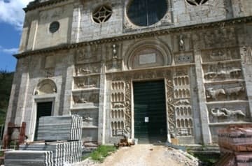 Lower facade of San Pietro, full of medieval reliefs.