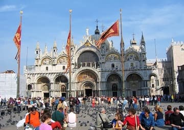 View of the west facade from busy St. Mark's Square. Basilica di San Marco, Venice, Italy.