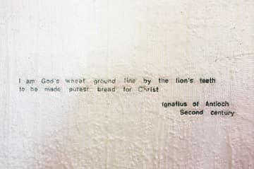A prayer by St. Ignatius of Antioch in gold leaf on the wax-covered walls of the Chapel of the Blessed Sacrament. It reads, "I am God's wheat ground fine by the lion's teeth to be made purest bread for Christ." Chapel of St. Ignatius (1997) by Steven Holl. Seattle University, Seattle, Washington, USA.