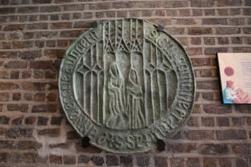 Large replica of the seal of St. Anne's Guild, mounted in the south aisle.