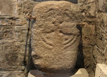 An early cross-carved slab in the porch.