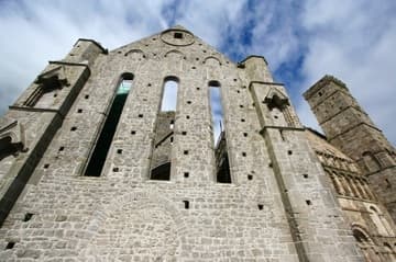 South transept of the cathedral (13th century), with a glimpse of Cormac's Chapel (12th century) on the right. Rock of Cashel, County Tipperary, Ireland.