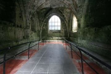 Inside the Chapter House, partially paved with medieval tiles.