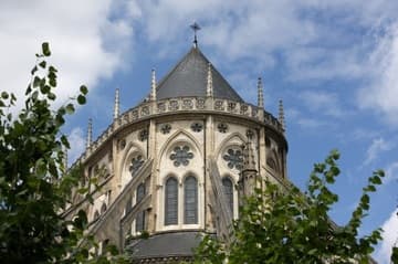 Exterior view of the apse of Bourges Cathedral (completed 1214), framed by trees.