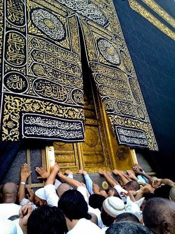 Pilgrims touch the gilded entrance to the Ka'ba, which is raised 2 meters above the ground.