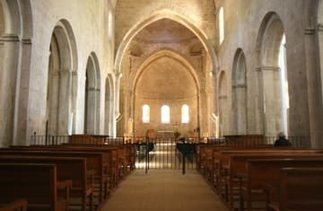 Interior of the abbey church, looking north to the apse. Nestled in a valley in Provence famed for its lavender fields, the Cistercian Abbey of Senanque was founded in 1148. The austere and harmonious church, built in the Romanesque style, was consecrated in 1178.