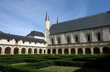 Looking northwest in the Grand-Moutier Cloister, reconstructed on the site of the Romanesque cloister by abbesses Renee de Bourbon (south gallery, 1519) and Louise de Bourbon (remaining galleries, 1530-60). Also visible is the south flank of the Romanesque abbey church (1105-60). Abbey of Fontevraud, Loire Valley, France.