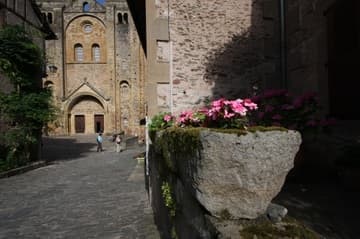 A glimpse of the west entrance from the medieval cobblestone path leading to the church.