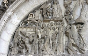 Detail of the Last Judgment tympanum over the west door, sculpted by Gislebertus around 1130. In the center, apostles incline their heads in veneration towards Christ. Above them, the enthroned Virgin Mary extends her hands in blessing and an angel trumpets to waken the dead.