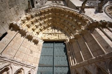 Left portal in the Gothic west facade of Poitiers Cathedral, dating from the late 13th century. The tympanum depicts the Dormition and Coronation of the Virgin.