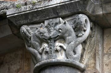 Exterior capital of friendly-looking monsters gnawing a plant.