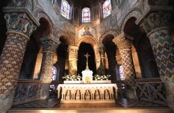 Chancel with stout pillars and painted Romanesque capitals.