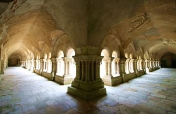 View inside the atmospheric cloisters at Fontenay Abbey.