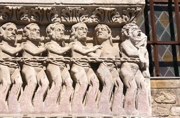 The damned are dragged in chains to hell at the Last Judgment. Detail of Romanesque portal, 12th century. Eglise St-Trophime, Arles, France.