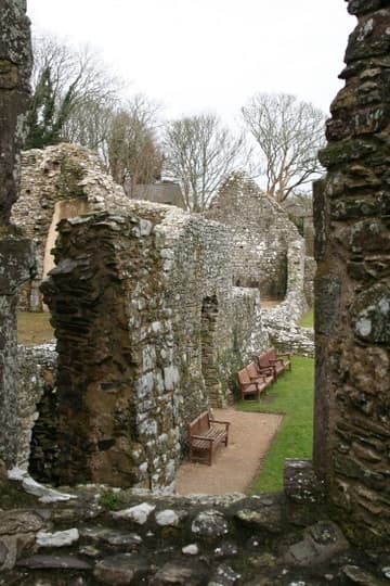 Ruined walls and benches for visitors.