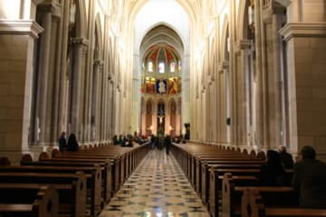 Neo-Gothic interior, with colorful murals visible in the apse.