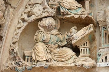 Saint Mark the Evangelist writes his gospel, helped by his lion symbol.